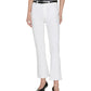 A person wearing a black sleeveless top, Frame's The Reboot Crop ultra-stretch denim bootcut jeans with a black belt, and black pointed-toe shoes, standing against a plain white background.