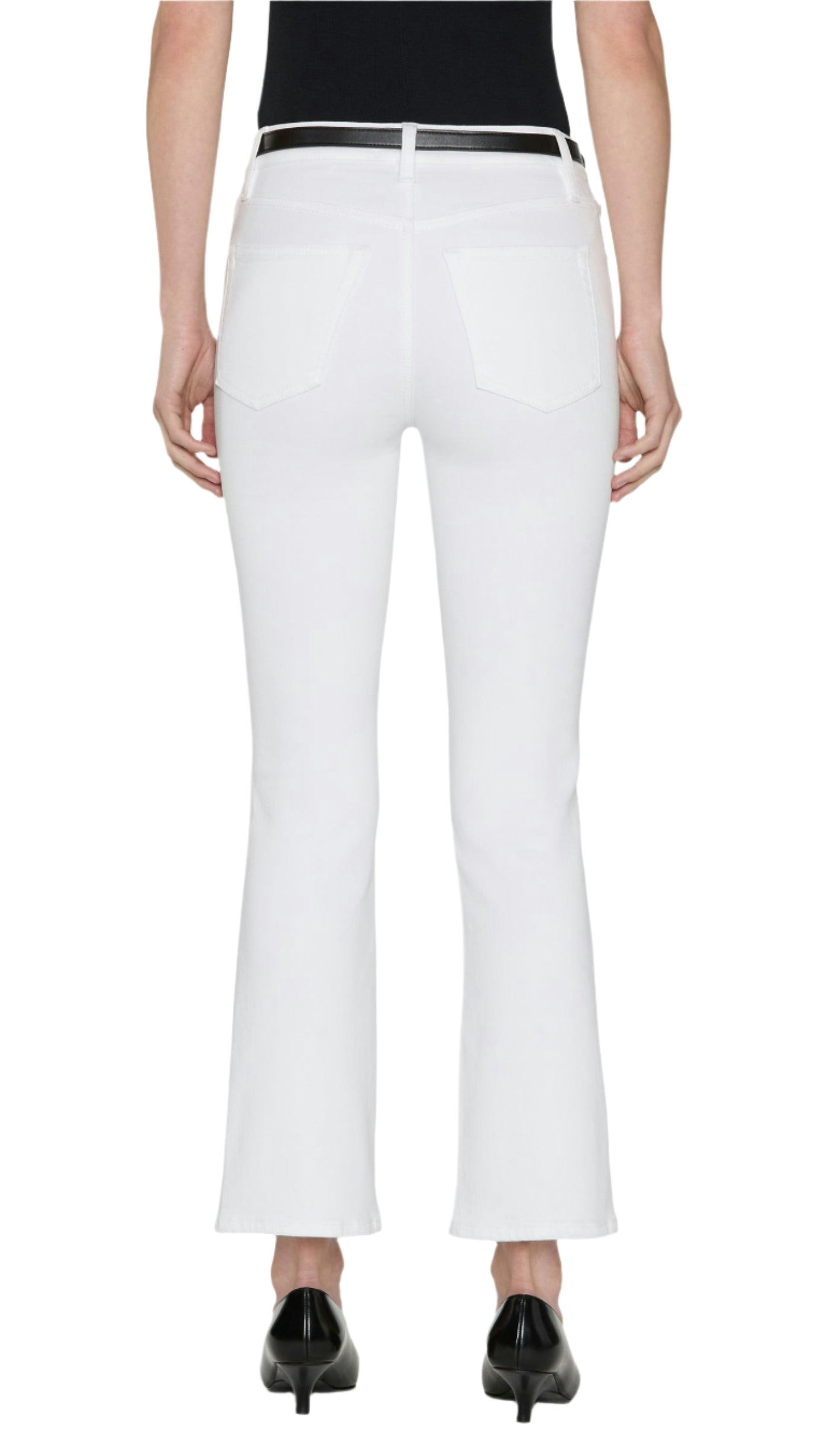 Person shown from the back wearing a black top, black belt, black heeled shoes, and Frame’s The Reboot Crop jeans in an ultra-stretchy cotton blend with a cropped inseam.