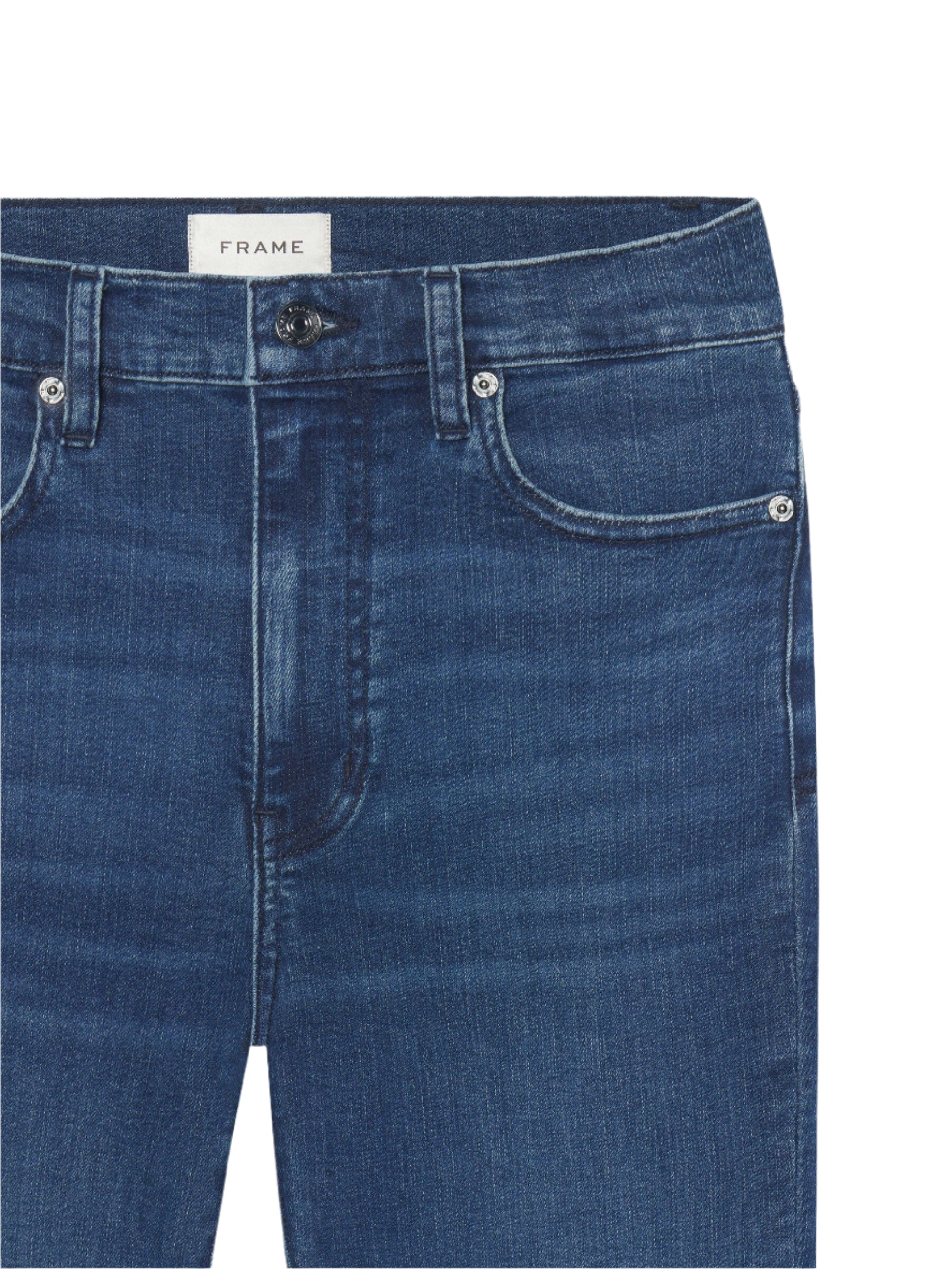 Close-up of the FRAME "The Reboot Crop" jean in blue denim, highlighting front pockets, button and zip closure, a FRAME label on the waistband, and ultra-stretchy cotton-blend fabric.