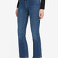 A person wearing a black long-sleeve top, The Reboot Crop blue ultra-stretchy cotton ankle-length jeans by Frame with a black belt, and black slingback heels.