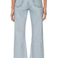 Person wearing Frame’s The Lax light blue high-waisted, wide-leg flare jeans in rigid denim with frayed hems, styled with a black belt and white sleeveless top, photographed from the back for a vintage look.