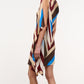 A person wearing the Staud Sabina Silk Dress, featuring an easy-fit column silhouette with a sleeveless, knee-length asymmetrical design and diagonal stripes in brown, beige, red, and blue, shown from the side against a plain background.