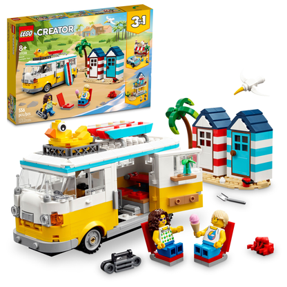 Legos - Toyhouse LEGO® Creator Beach Camper Van set featuring a yellow and white Camper Van, two beach huts, a bird, and two minifigures with accessories. The box in the background showcases the complete set on a stunning summerhouse beach scene.