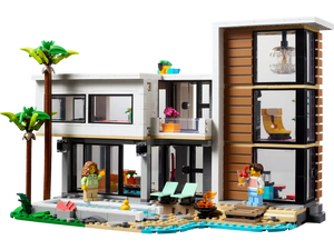 The LEGO® Creator Modern House by Legos - Toyhouse includes a stylish palm tree, sparkling pool, two cozy lounge chairs, and a charming fire pit. This set comes with two minifigures for imaginative play.