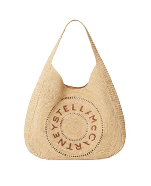 The Logo Raffia Slouchy Large Tote Bag by Stella McCartney features beige woven raffia, a circular logo on the front, and a wide shoulder strap. This vegan tote combines signature style with sustainable design.