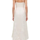 A woman in Simkhai's Annabella Soutache Dress—white, sleeveless, with thin straps and delicate embroidery—seen from the back and paired with heeled sandals.