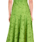 A woman wearing the Simkhai Imogen Midi Dress in Kiwi—a strapless, ankle-length summer jacquard with a textured floral pattern—stands with her back to the camera.
