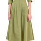A woman wears the Simkhai Signature Jazz Dress, a light green, collared cotton poplin button-down midi with pleats and an A-line silhouette, paired with white heeled sandals.