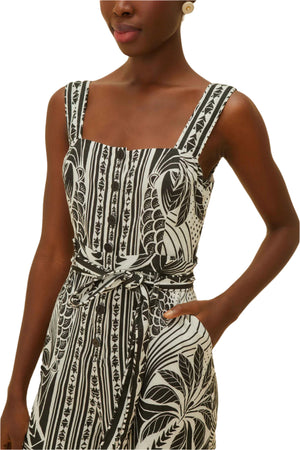 A woman radiates style in the Farm Rio Monochrome Elegance Scarf Off White Romper, confidently posing with one hand on her hip.