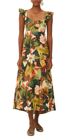 A woman wears the Farm Rio Botanical Forest Multicolor Scoop Neck Ruffled Strap Dress with a vibrant botanical print and brown flat shoes.