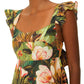 Woman wearing a Farm Rio Botanical Forest Multicolor Scoop Neck Ruffled Strap Dress with gold heart-shaped earrings.