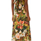 A person wears the Farm Rio Botanical Forest Multicolor Scoop Neck Ruffled Strap Dress, featuring a low back and large bow tie, paired with flat woven shoes.