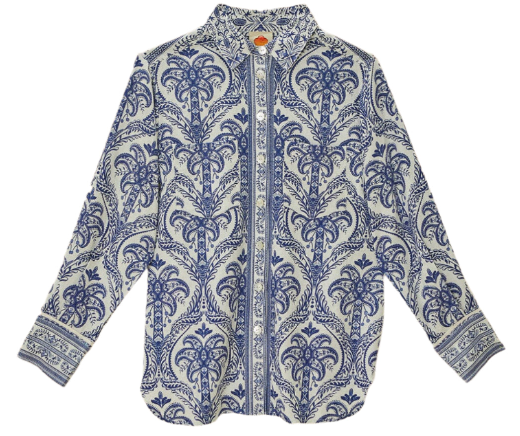 The Blue Tropical Cameo Off-White Pajama Shirt by Farm Rio features blue and white paisley and floral prints, crafted from LENZING™ ECOVERO™ eco-responsible fibers, shown flat on a white background.