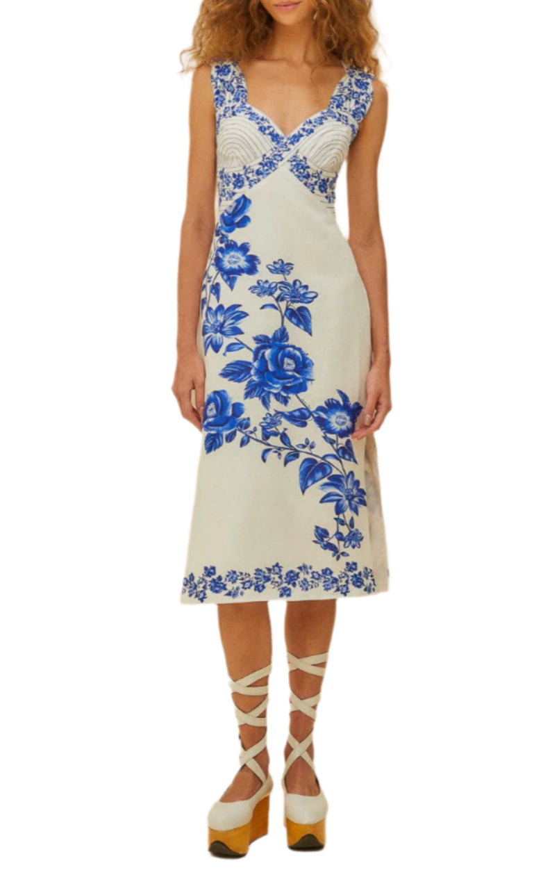 A woman wears the Farm Rio Off-White Floral Cascade Wavy Midi Dress, styled chicly with platform shoes featuring crisscross ankle straps.