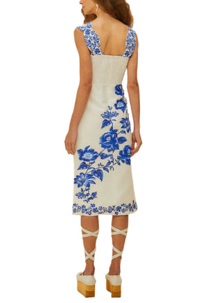 A woman, seen from behind, wears the Farm Rio Off-White Floral Cascade Wavy Midi Dress with platform sandals and hoop earrings.