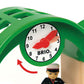 A clock with a red hand and a green object with a BRIO World railway set.