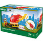 Box labeled "Brio World" showcasing a Brio World Firefighter Helicopter set for children aged 3 and up. The set includes a red helicopter, a firefighter figure acting as the pilot, and accessories vital for ensuring an effective water supply.