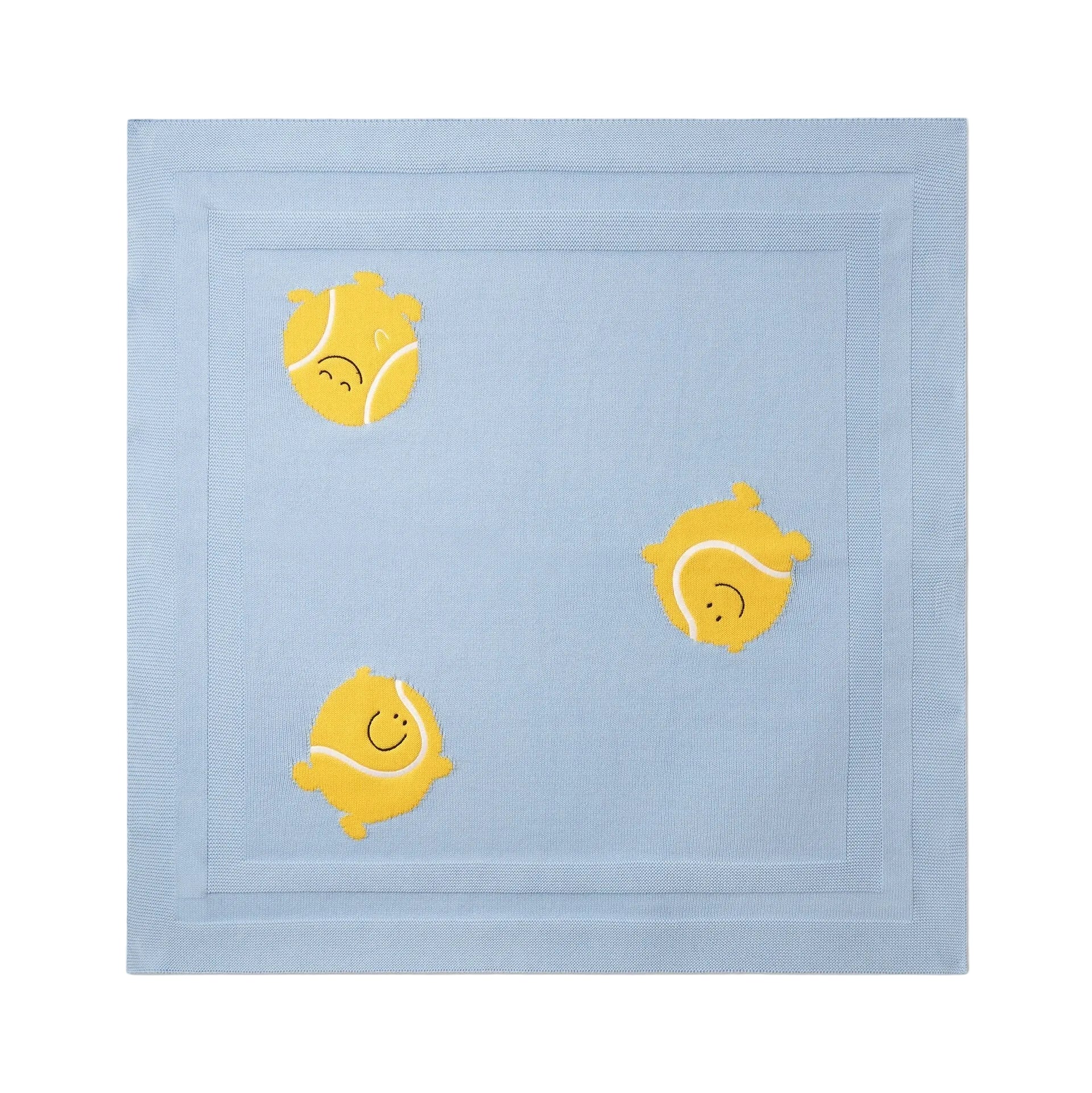 The Baby Knit Tennis Blanket by Stella McCartney Kids is crafted from organic cotton and features playful embroidered yellow tennis balls with smiling faces on a light blue background.
