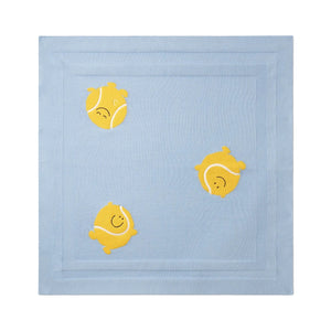 The Baby Knit Tennis Blanket by Stella McCartney Kids is crafted from organic cotton and features playful embroidered yellow tennis balls with smiling faces on a light blue background.