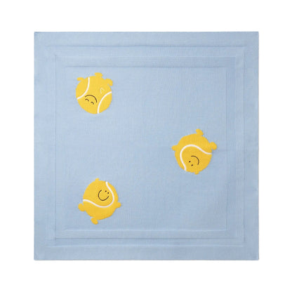 The Baby Knit Tennis Blanket by Stella McCartney Kids is crafted from organic cotton and features playful embroidered yellow tennis balls with smiling faces on a light blue background.