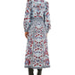 A woman is seen from the back wearing the Farm Rio Marcelle Maxi Dress, an ankle-length floral dress in blue, red, and white hues, styled with black heeled boots.