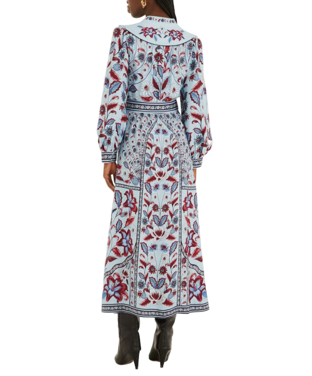 A woman is seen from the back wearing the Farm Rio Marcelle Maxi Dress, an ankle-length floral dress in blue, red, and white hues, styled with black heeled boots.