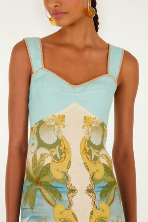 A woman wears the Farm Rio Royal Sea Multicolor Maxi Dress, featuring aqua blue straps, a sweetheart neckline, and a tropical palm tree and seashell print.