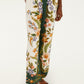 Someone wears Farm Rio Nature Sand Pants—high-waisted, wide-leg with a green and white floral print—paired with brown woven flat shoes.