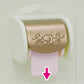 A decorative gold and white Calico Critters Toilet Seat dispenses a pink roll, with a pink arrow pointing down at the paper—an elegant addition to any toilet set or useful for encouraging little ones during toilet training.