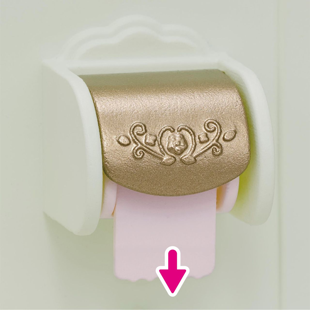 A decorative gold and white Calico Critters Toilet Seat dispenses a pink roll, with a pink arrow pointing down at the paper—an elegant addition to any toilet set or useful for encouraging little ones during toilet training.