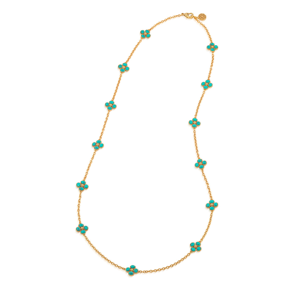 The Juliska Capucine De Wulf Berry Clover Double Sided Necklace features turquoise clover charms spaced along a delicate gold station chain, displayed in an oval on a white background.
