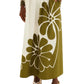 A person wearing the Farm Rio Palermo Green Midi Skirt with bold floral patterns, a patterned long-sleeve top, and platform sandals.