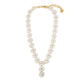 The Juliska Capucine De Wulf Mermaid Garden Petite Riviere Convertible Necklace features white flower beads, golden berry accents, an adjustable chain, a dangling floral pendant, and a round charm at the end.