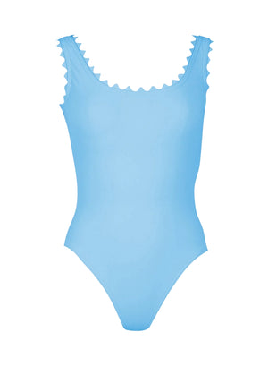 The Karla Colletto Ines Round Neck One Piece is a light blue swimsuit with delicate rick rack trim on the neckline and shoulder straps, shown against a white background.