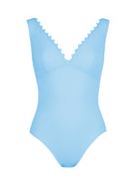 The Ines V-Neck One Piece by Karla Colletto is a light blue swimsuit with a V-neckline and whimsical rick rack edging along the neckline.