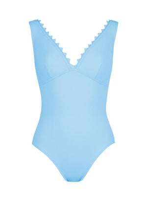 The Ines V-Neck One Piece by Karla Colletto is a light blue swimsuit with a V-neckline and whimsical rick rack edging along the neckline.