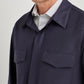 Canali Relaxed Fit Overshirt in dark navy, featuring a relaxed fit and two chest pockets, worn over a striped dress shirt.