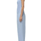 A woman stands in profile wearing the Simkhai Emerson Ruched Bustier Top in light blue, paired with matching high-waisted, wide-leg pants and white slide sandals.