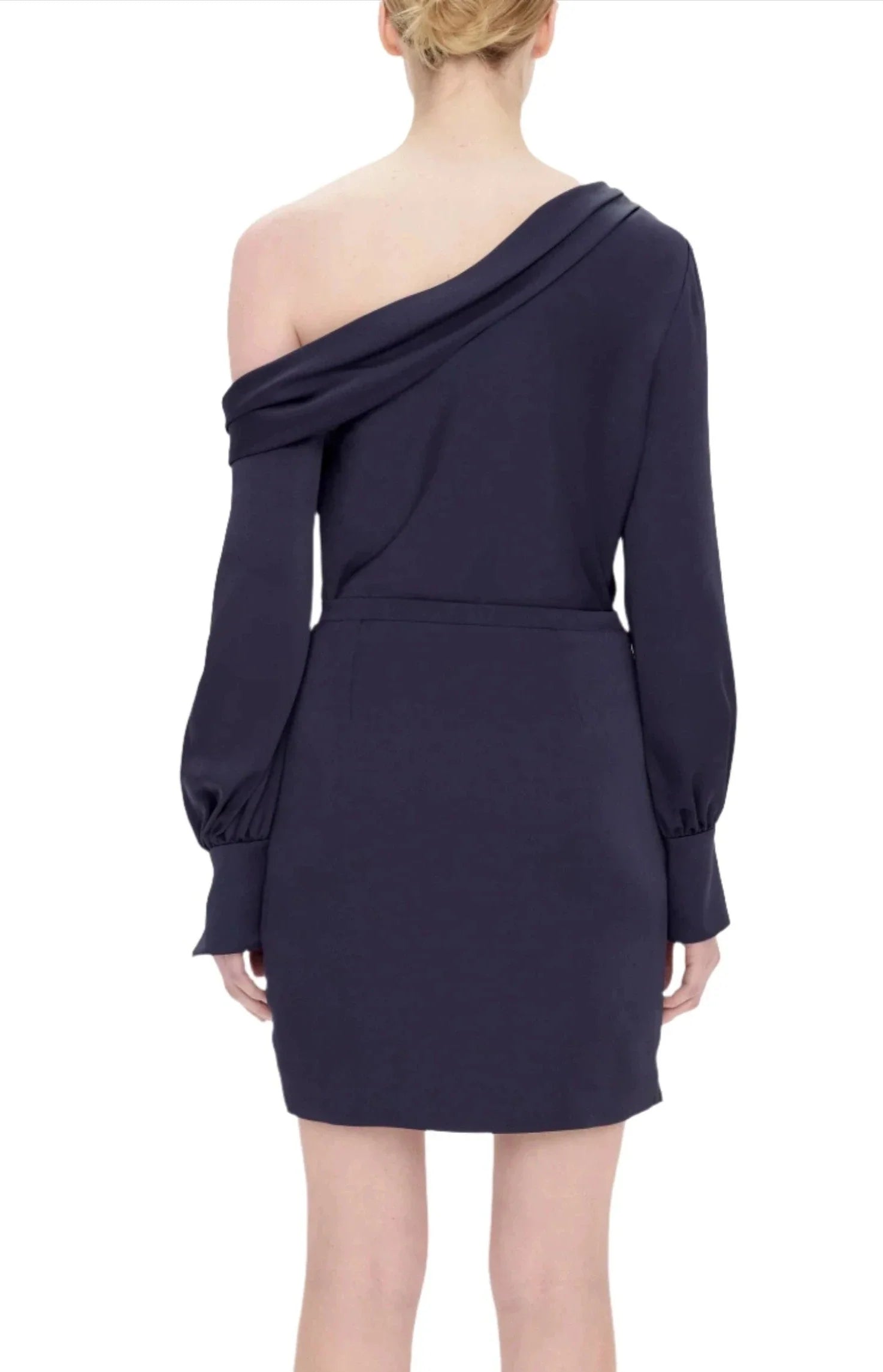 A person is wearing a dark blue Simkhai Cameron One Shoulder Mini Dress made of high sheen satin, viewed from the back.