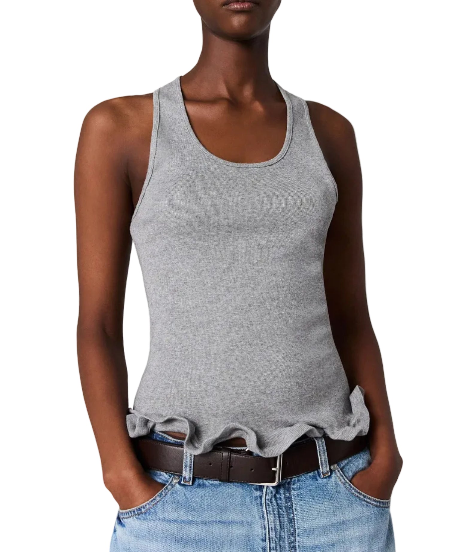 A person wearing the Stella McCartney Frilled Hem Rib Tank with blue jeans and a brown belt, standing with hands in pockets.