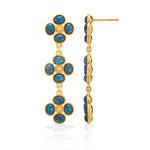 The Juliska Capucine De Wulf Berry Clover Linear Earrings feature gold-tone drop designs with three floral clusters and oval blue stones—shown from multiple views, they're a stylish gemstone jewelry addition.