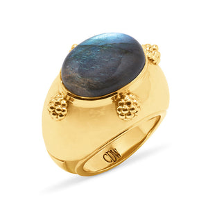 The Cleopatra Oval Ring by Juliska Capucine De Wulf features a blue labradorite gemstone and gold bead accents, engraved with "CDR" inside—the perfect blend of elegance and intrigue.