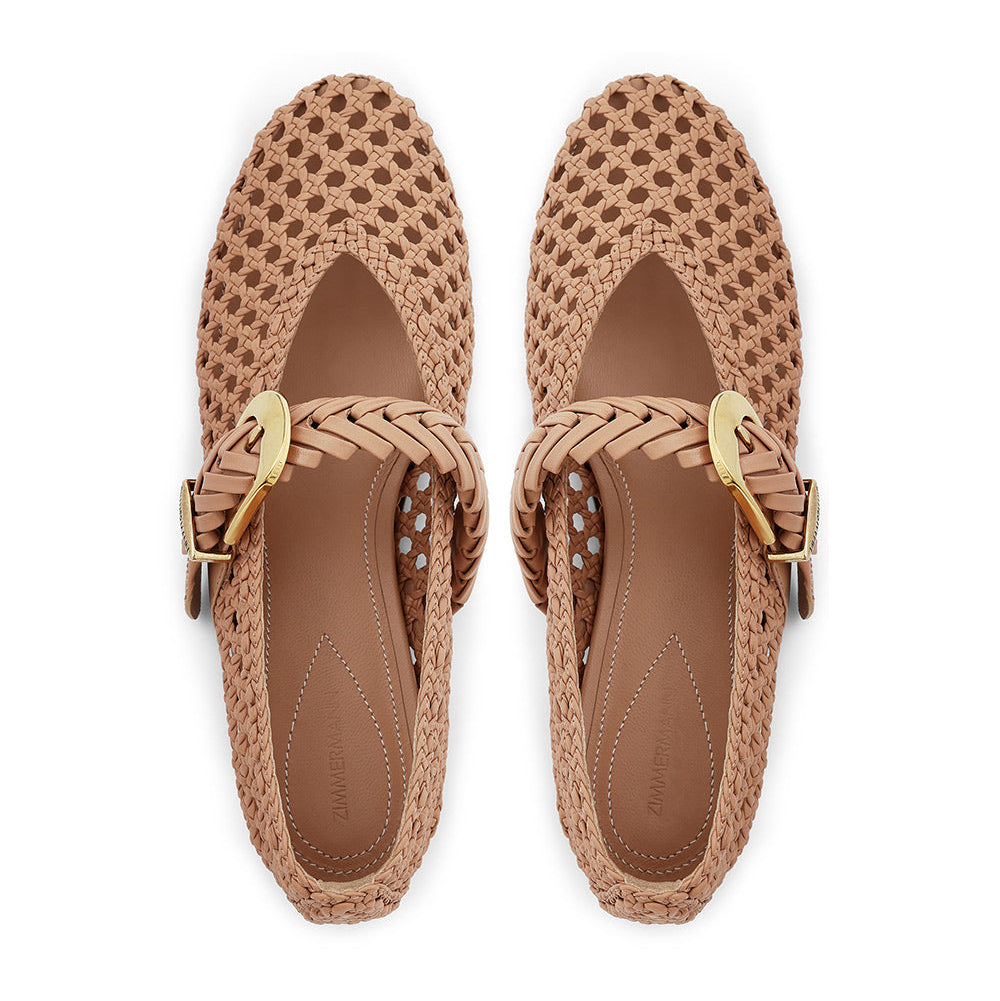 Top view of a pair of tan Alchemy Ballerina shoes by Zimmermann with braided weaving, gold hardware buckles, and brown insoles.