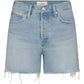 The Everyday Short by Frame features light blue pure cotton denim, a 4" inseam, frayed hem, five pockets, belt loops, and front button and zip closure.
