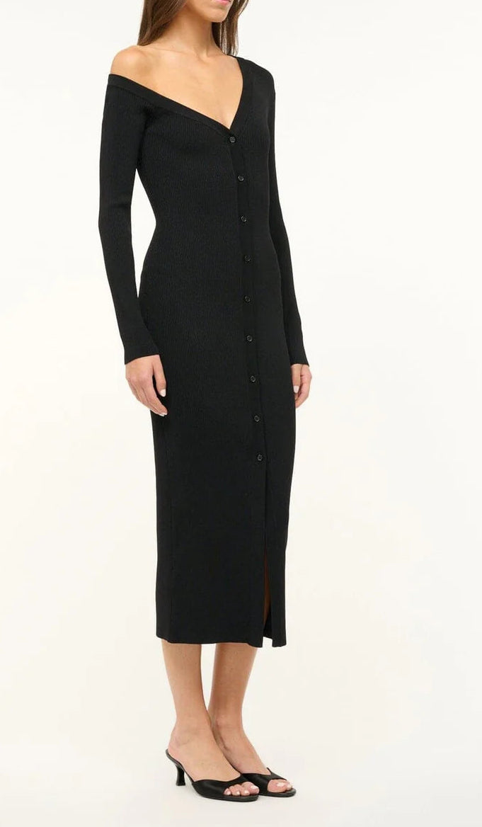 A woman styles a long-sleeved, button-down black midi dress with an off-the-shoulder neckline and Staud Brigitte Satin Mules—open-toe kitten heels ideal for versatile dressing.