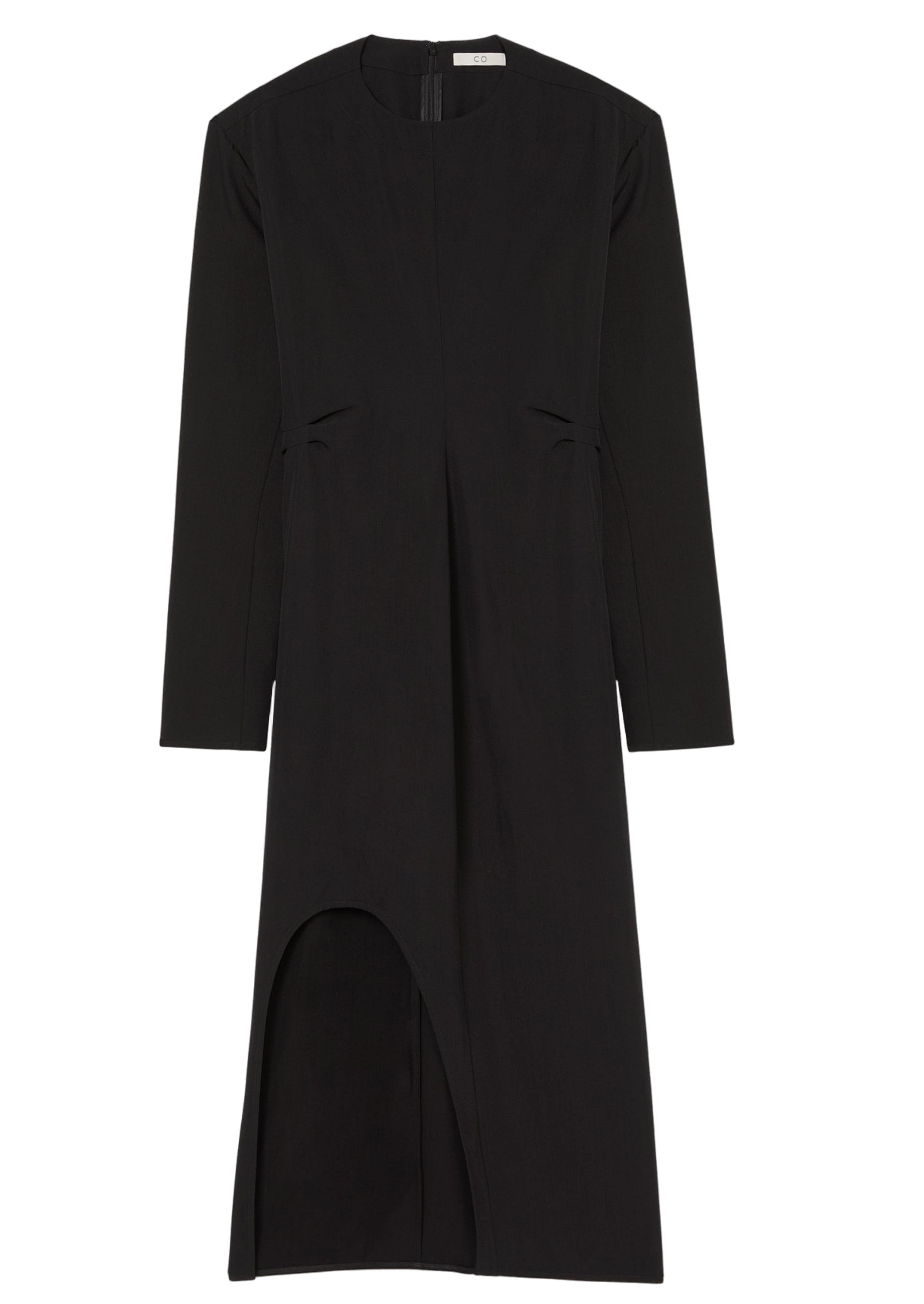 The Keyhole Dress by CO is a minimalist black long-sleeved dress in a viscose-wool blend, featuring a fitted waist, knee-length hem, and an asymmetrical front slit.