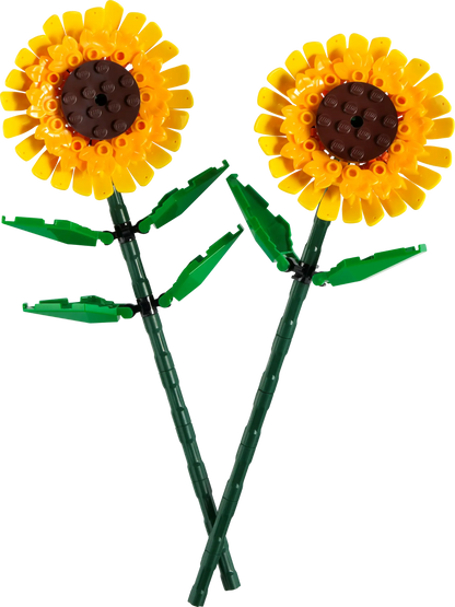 The LEGO® Sunflowers by Legos - Toyhouse offer a vibrant display with two plastic sunflowers featuring yellow petals, brown centers, and lush green stems and leaves. These cheerful blooms evoke the playful nature of a LEGO building kit, adding warmth to any setting.