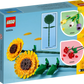 The LEGO® Sunflowers box from Legos - Toyhouse showcases vibrant sunflowers on a blue background, with inset images of other flower sets and a dimension diagram, making it an ideal addition for enthusiasts.