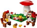 Two hedgehog LEGO figures enjoy a picnic with cups, food, and a large mushroom in the LEGO® Hedgehog Picnic Date set by Legos - Toyhouse—the perfect animal toy build or playful gift for fans of whimsical scenes.