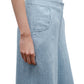 A person wearing the TWP Demi Hemp Denim Pant in light blue, a high-rise, wide-leg style, stands with their left arm relaxed by their side, shown from waist to mid-thigh.